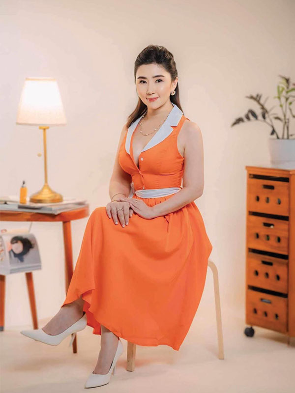 Nikki Tang wearing pretty orange dress